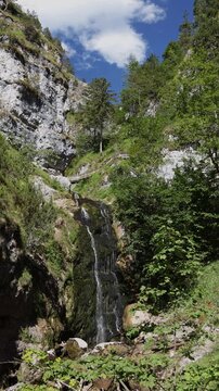 Scenic Wasserlochklamm waterfall in Palfau, Austria. Mountain gorge trail in the Alps with a wooden hiking bridge