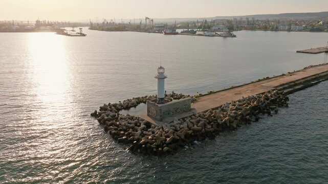 Varna port lighthouse breakwater aerial drone view Black Sea harbor pier sunset golden light maritime navigation Bulgaria summer travel landscape destination