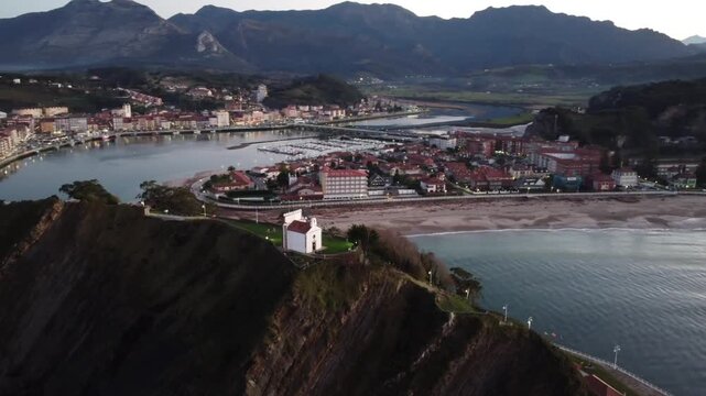 Aerial view of Ribadesella and its estuary at sunset in Asturias, Spain.