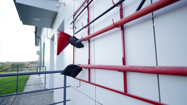 Emergency equipment station hang near safety handrails. Sharp daylight focus conveys proper public security and utility maintenance