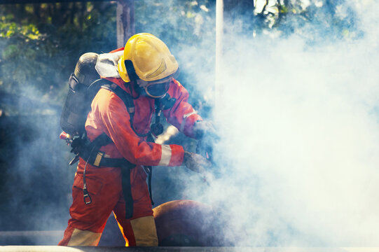 Firefighter in full gear battles thick smoke