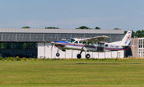 Skydiving and extreme sports concept Cessna Supervan 900 parachute jump plane landing on a grass airstrip at Hoogeveen airport in the Netherlands