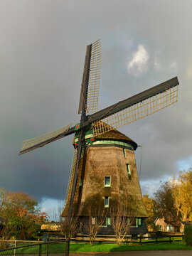 Dutch windmill in Waarland Netherlands traditional architecture and cultural heritage polder landscape with dramatic sky The iconic structure stands on a dramatic sky
