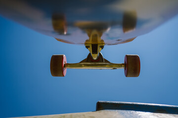Close up view of skateboard trucks and wheels above a skate ramp © yossarian6