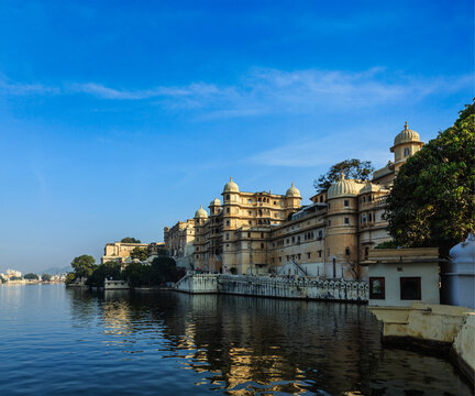 Romantic India luxury tourism concept backdrop - Udaipur City Palace and Lake Pichola. Udaipur, Rajasthan, India
