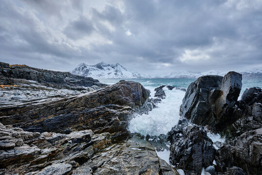 Scene featuring waves of Norwegian sea crushing at rocky coast in fjord. Vikten, Lofoten islands, Norway