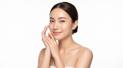 Beautiful young Asian woman with perfect glowing skin touching her face on a white background. Ideal for beauty and skincare advertising.