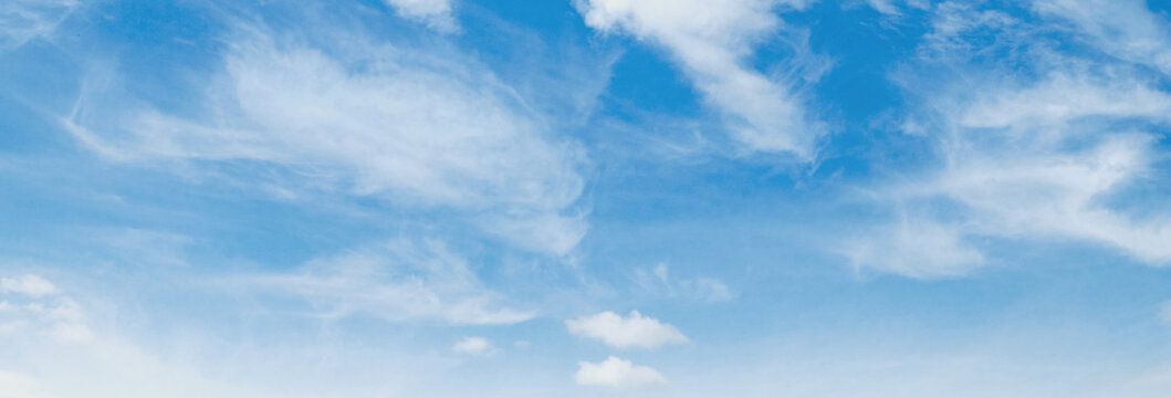 Clear blue sky with wispy white clouds