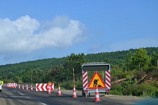 Road repairs and temporary traffic management on the A-6 motorway in Spain. Traffic cones, warning signs and a mobile information board guide traffic, June 29, 2026