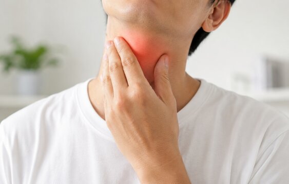Man Suffering from Sore Throat and Thyroid Pain Touching His Neck