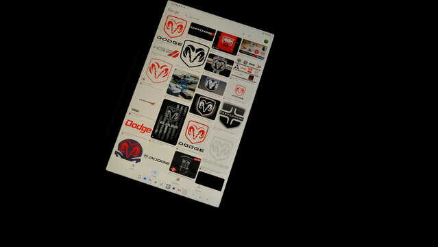 Tablet screen view with various sized Dodge logos, on a black background, August 1, 2026