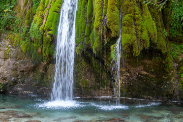 Kaghu Waterfall, located in the Samegrelo region of Georgia, A vibrant waterfall cascades down a mossy stone © k_samurkas