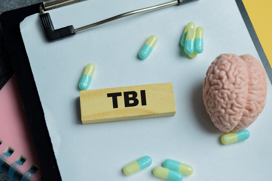 Concept of TBI - Traumatic Brain Injury text on wooden blocks.