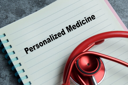Concept of personalized medicine write on book isolated on Wooden Table.