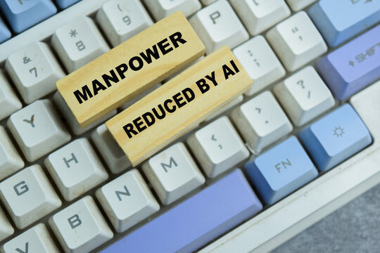 Concept of manpower reduced by AI text on wooden blocks.