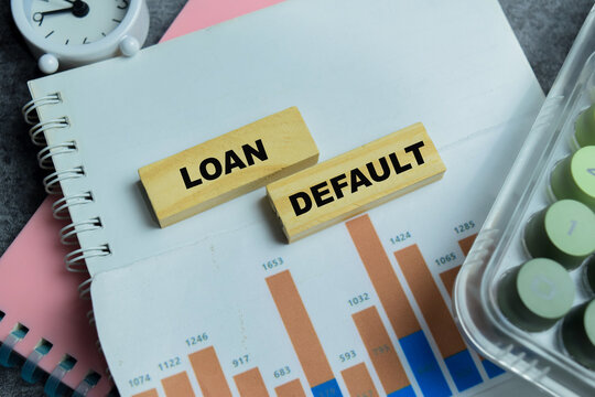 Concept of loan default text on wooden blocks.