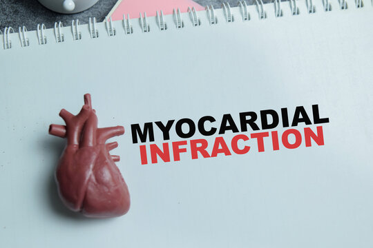 Concept of myocardial infraction write on book isolated on Wooden Table.