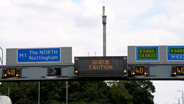 Signboard, road, sign, matrix, queue, overhead digital variable message motorway gantry sign displaying Queue Caution on M1 UK highway