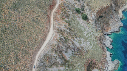 Top down aerial view of dirt road with driving cars along rocky coast and blue sea to Balos lagoon in Gramvousa Crete Greece for travel adventure stock photo © moryachka