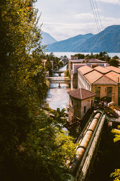 Historic penstock pipe descending the hillside toward the Bellano lakeside village