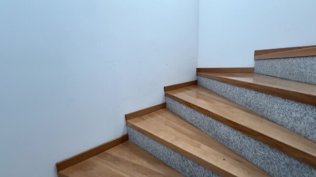 Staircase progression with wooden steps and decorative railing leading upward in a bright interior setting