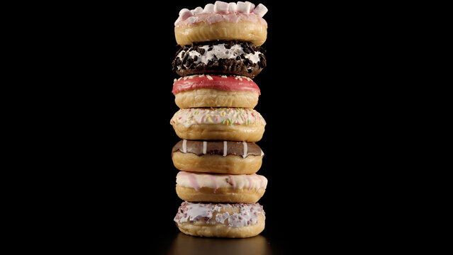 Stack of seven assorted donuts with various toppings