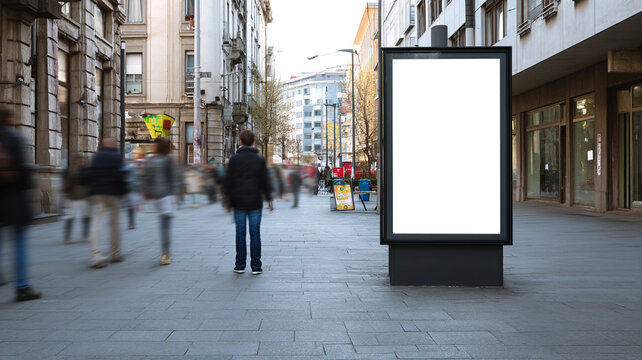 urban street scene with a blank vertical billboard mockup, modern lightbox display in the center of a city sidewalk, pedestrians walking past with motion blur