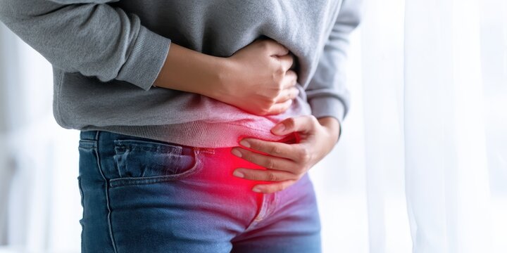 Stomach pain. Young woman touches her abdomen to acute pelvis pain. Glowing red light sign painful cramp, menstrual cycle distress ache or digestive spasm. Bladder infection symptom. Belly discomfort