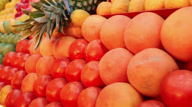 Colorful Fresh Fruit Display With Mangoes Apples And Limes At A Market Stall