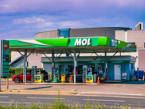 Prague, Czech Republic - August 1, 2026: MOL fuel station with multiple vehicles at fuel pumps, branded canopy, price board, and everyday refueling activity at a modern service station.