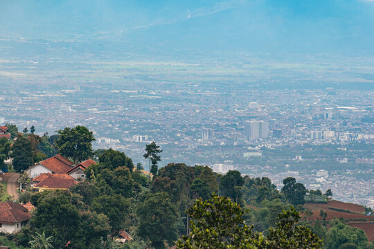 Scenic panoramic view of Bandung city skyline from Puncak Kordon in West Java, Indonesia with urban landscape and surrounding hills