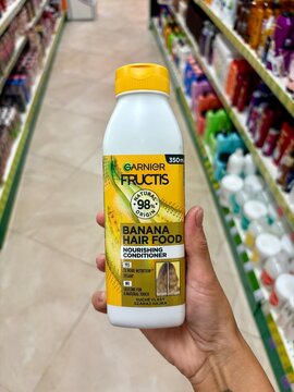 01.08.2026 Ukraine, Kharkov Woman Holding Garnier Fructis Banana Hair Food Conditioner