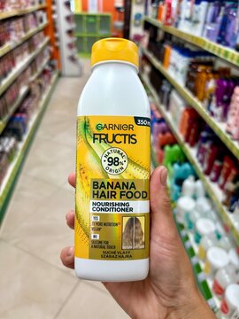 01.08.2026 Ukraine, Kharkov Woman Holding Garnier Fructis Banana Hair Food Conditioner