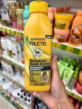 01.08.2026 Ukraine, Kharkov Woman Holding Garnier Fructis Banana Hair Food Shampoo