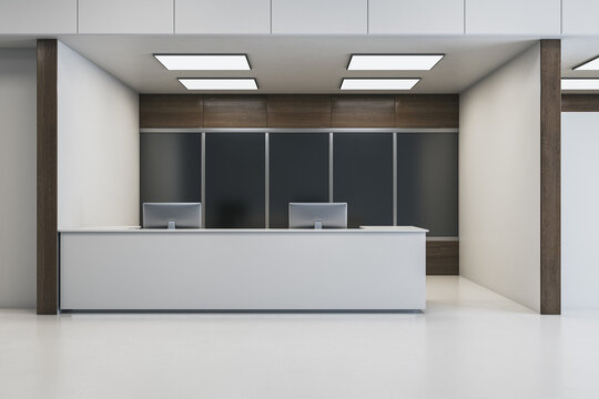 Modern reception desk with sleek design and dual computer stations in contemporary office space