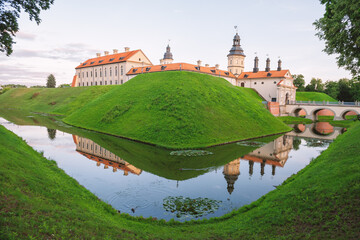 Naklejka premium Historic castle reflects across tranquil water