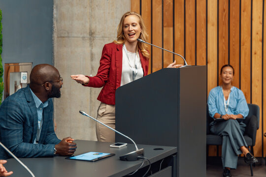 Business conference with speaker presenting to audience in a modern setting