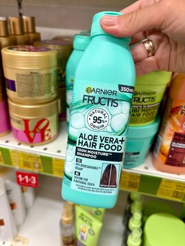 01.08.2026 Ukraine, Kharkov Woman Holding Garnier Fructis Aloe Vera Hair Food Shampoo