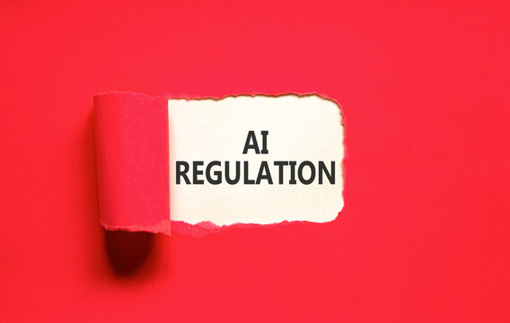 AI regulation symbol. Concept words AI artificial intelligence regulation on beautiful white paper. Beautiful red background. Business AI artificial intelligence regulation concept. Copy space.