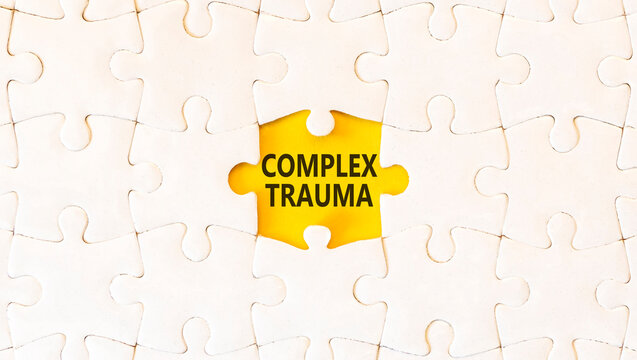 Complex trauma words symbol. Concept words Complex trauma on beautiful yellow paper. Beautiful white puzzles background. Psychological complex trauma support concept. Copy space.