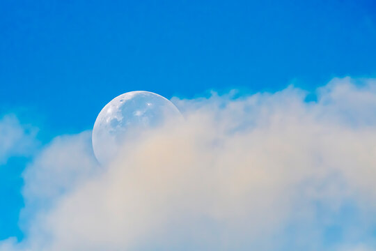Buck Moon Setting Partially Obscured by Clouds