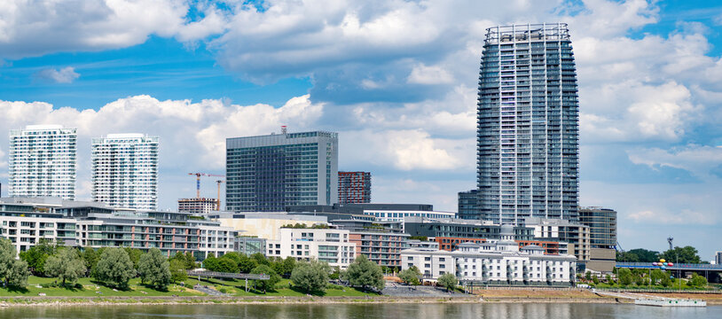 Modern building at river. Skyscraper in city downtown. City with skyscraper. Office building in business district. Skyscraper building architecture. Business skyscraper cityscape