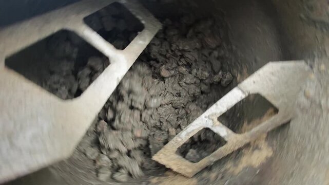Inside a concrete mixer drum rotating blades and centrifuge action