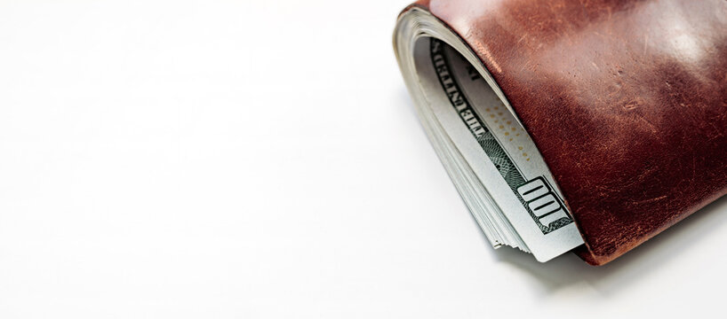 Brown Leather Wallet Full of US Dollar Bills Concept