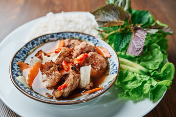 Vietnamese traditional grilled meat bun cha meal with noddle and salad Bún Chả in nước mắm...