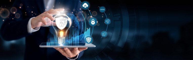 Businessman using a tablet to analyze Cybersecurity data and digital innovation. Network protection, threat detection, data security, risk management, information protection. © Theyone