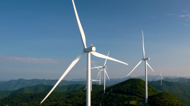 Wind Farm on Mountain Ridge Against Blue Sky