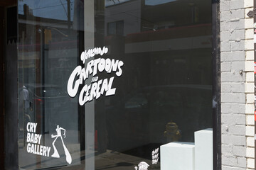 Fototapeta premium vinyl window signs at Cry Baby Gallery, a hidden speakeasy cocktail and oyster bar located behind an active art gallery at 1468 Dundas St W, Toronto