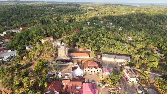 Aerial drone view of lush tropical coastal village and Indian Ocean coastline in Hiriketiya Dikwella Sri Lanka
