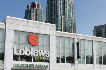 Fototapeta premium exterior building facade and logo sign of Loblaws, a grocery store chain, located here at 396 St Clair Av W, Toronto